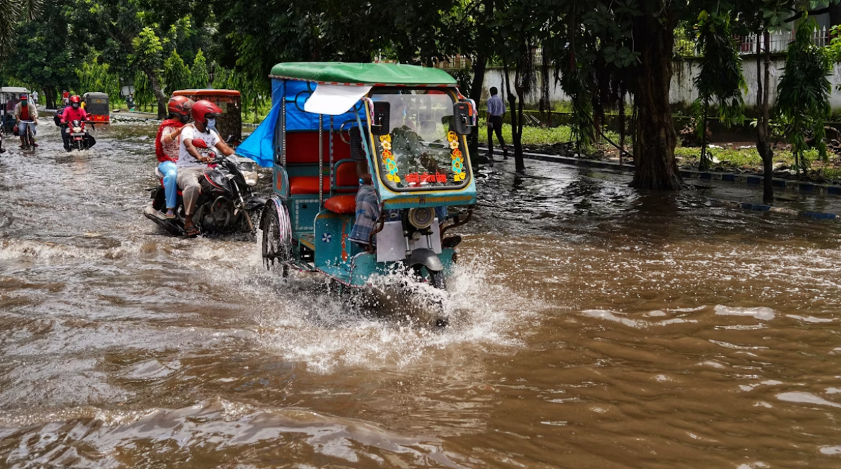 Tuktuk driving on a flooded road in Thailand