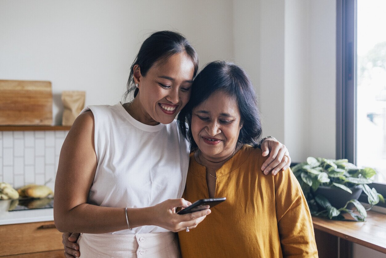 Mom and daughter calling someone on the phone