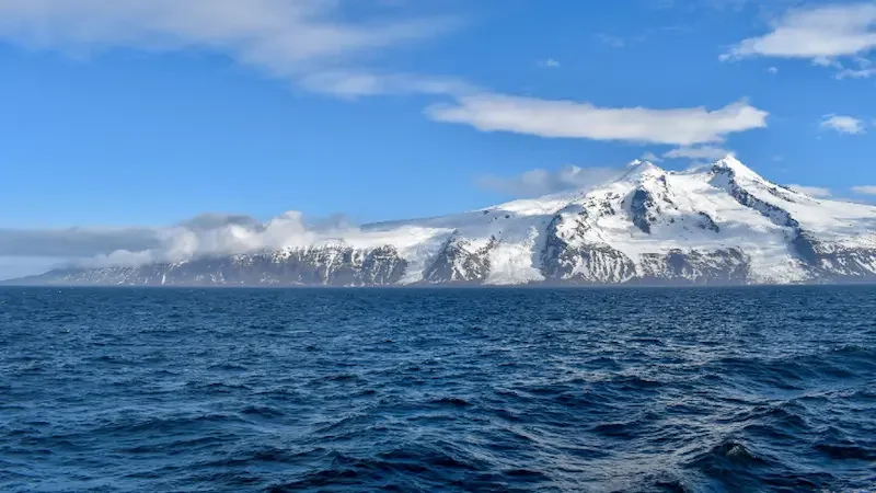 The snow-covered Beerenberg stratovolcano rising above Jan Mayen Island in the Arctic Ocean, Norway.