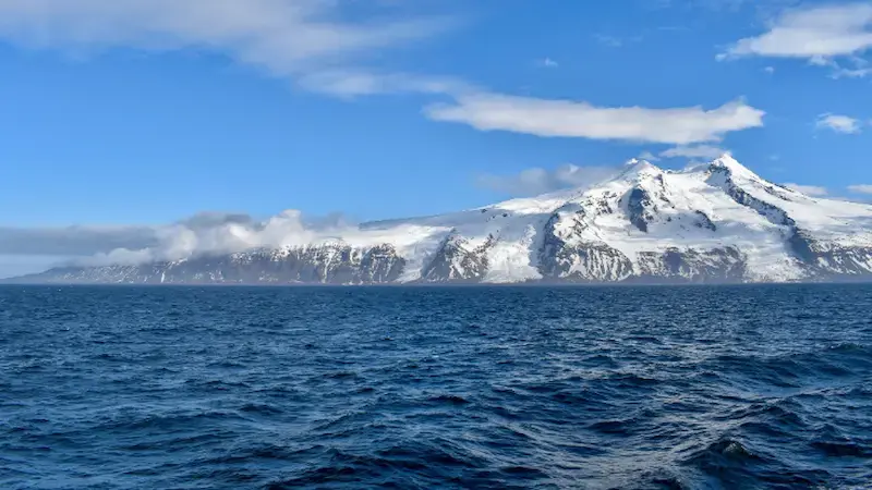 The snow-covered Beerenberg stratovolcano rising above Jan Mayen Island in the Arctic Ocean, Norway.