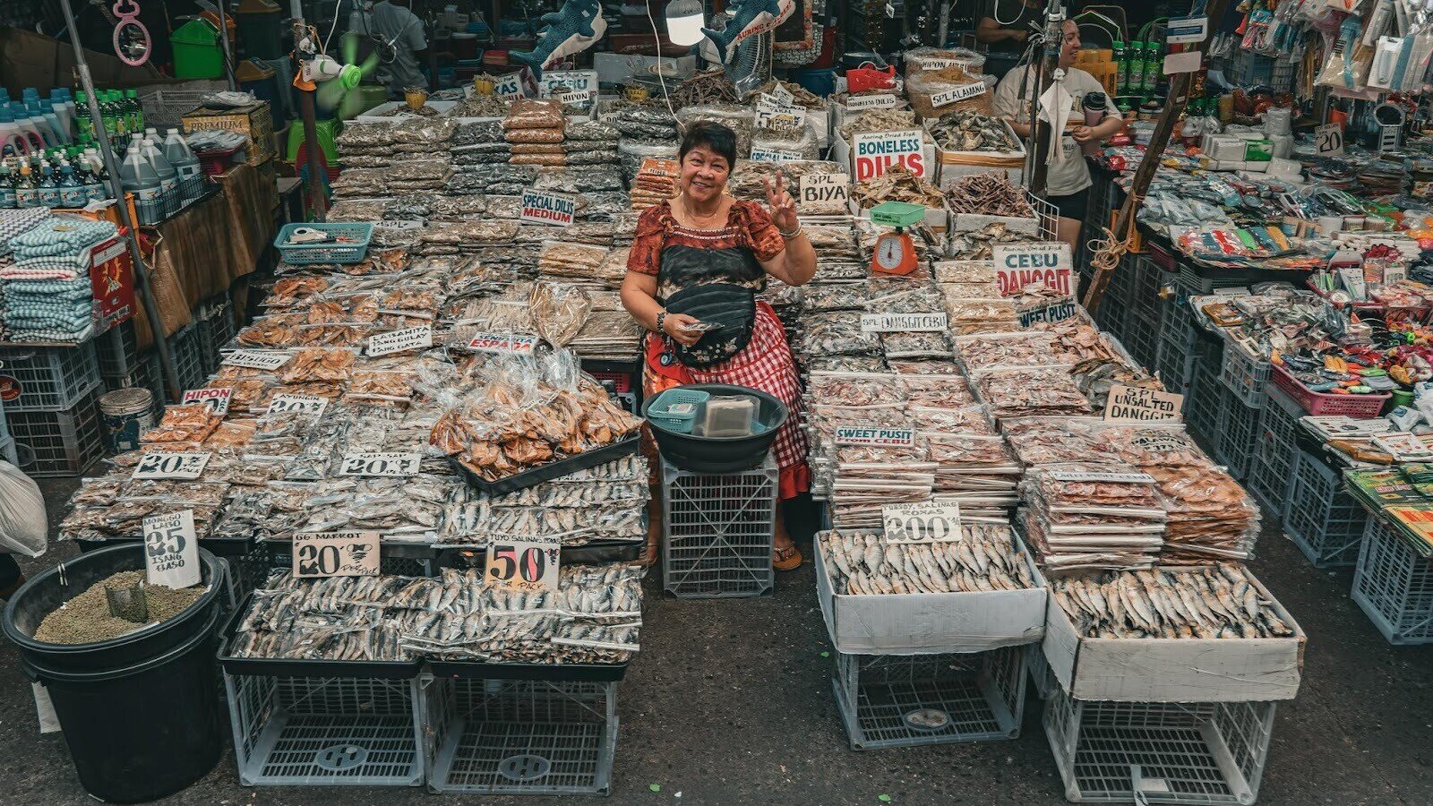 Woman waving at camera in a Manila fish market