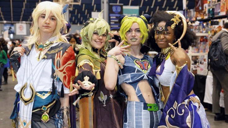 A group of four people dressed up in colourful cosplay outfits at the Heroes Dutch Comic Con event. 