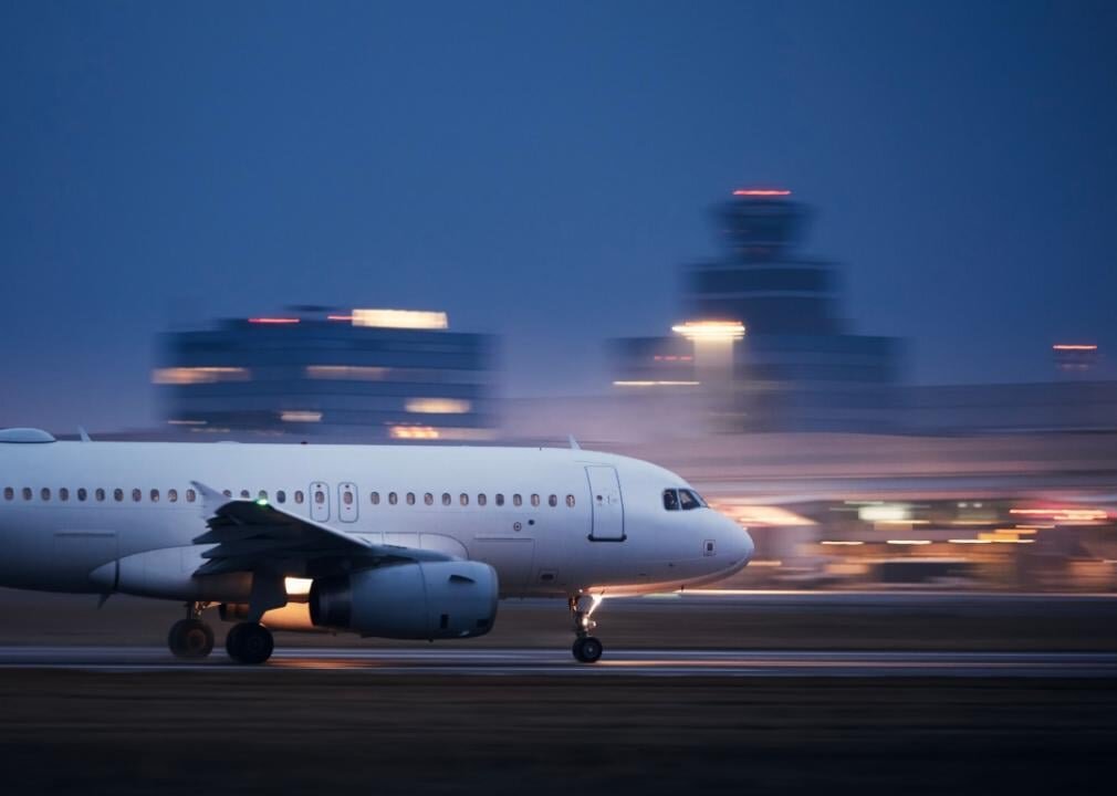A large airplane taking off from a runway at night.