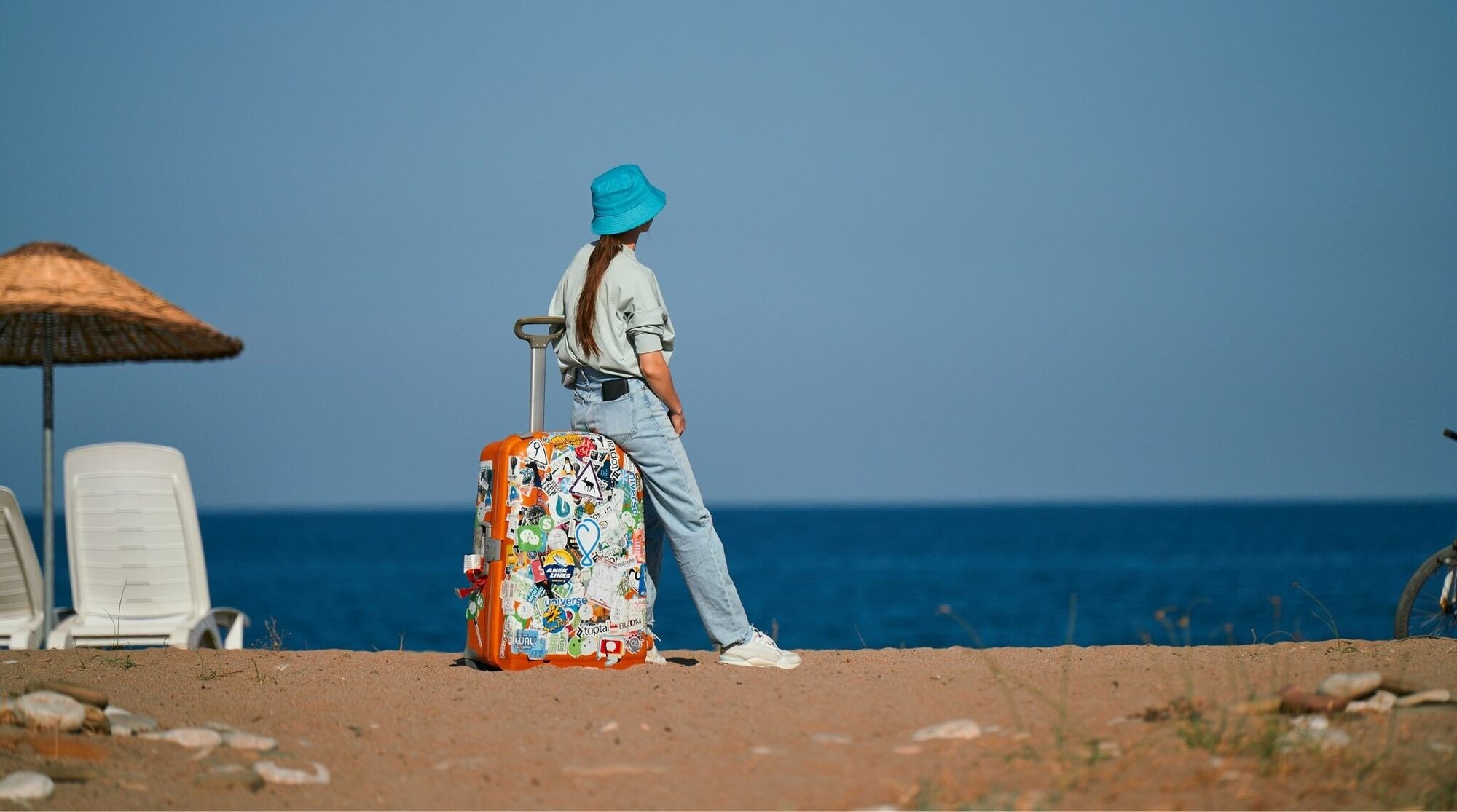 touriste avec valise sur la plage