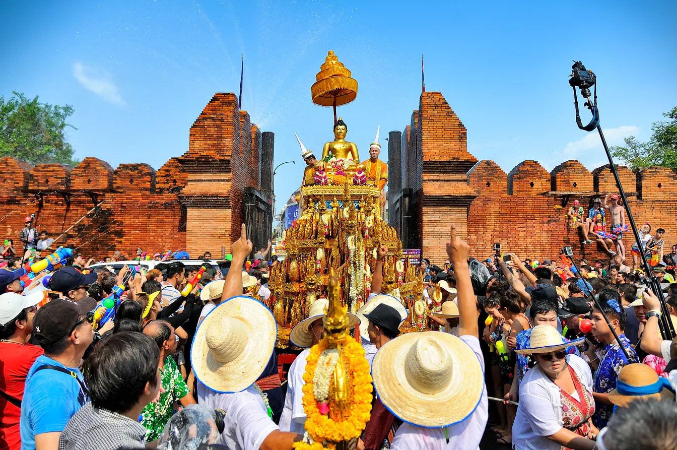 People carrying a Buddha statue in Chiang Mai during the Songkran festival.