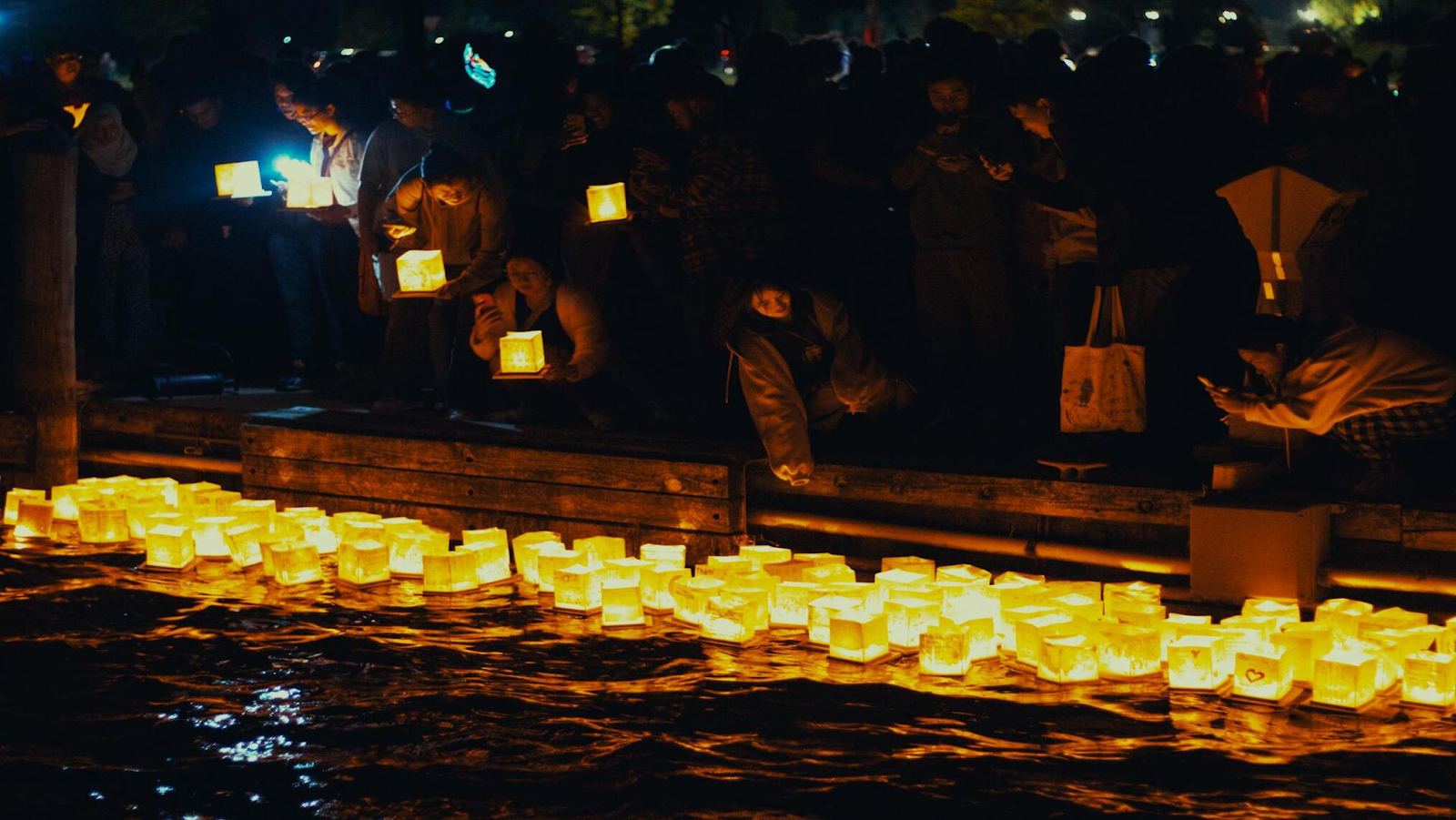 Lanterns floating on water at night