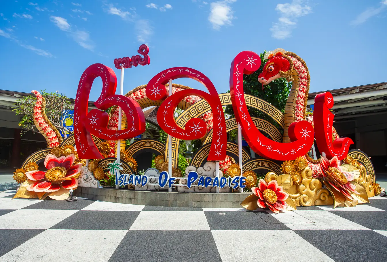 Letrero lleno de adornos balineses situado en el aeropuerto de Ngurah Rai, Bali.
