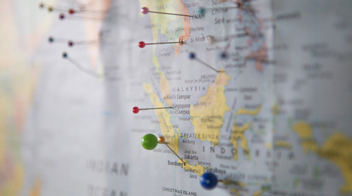 Map of the world with pins in it