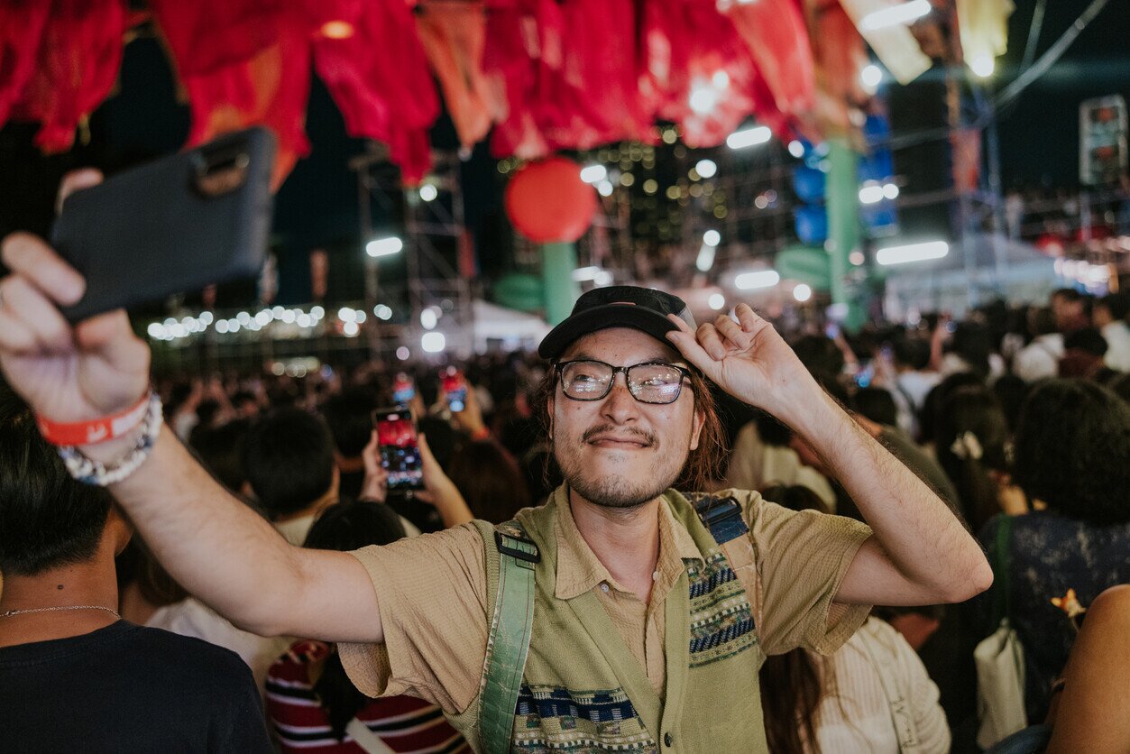 Man taking a selfie in a crowd