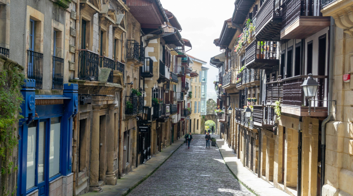 Houses bordering a cobblestone street in Hondarribia, Spain