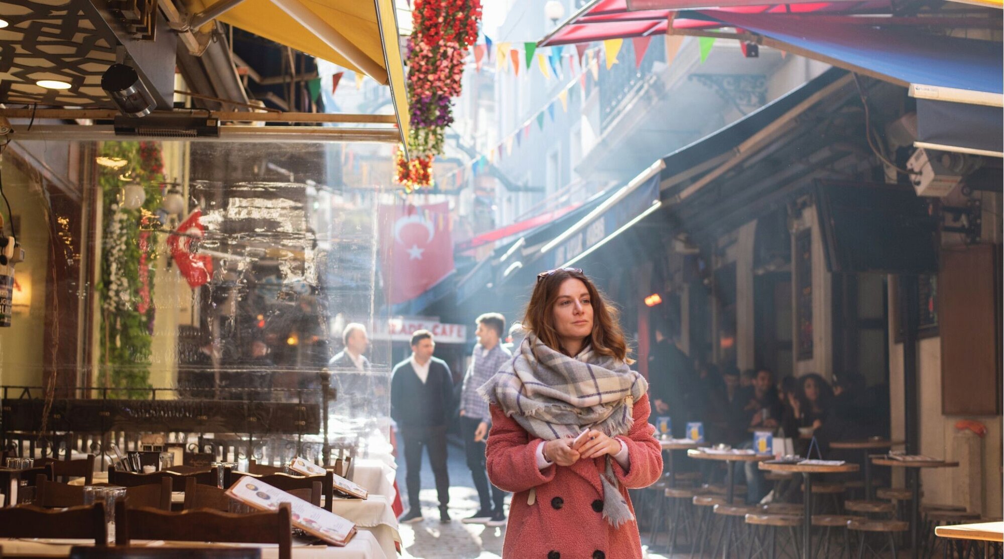 Mulher viajante caminhando por rua de restaurantes tradicionais em Istambul, Turquia.