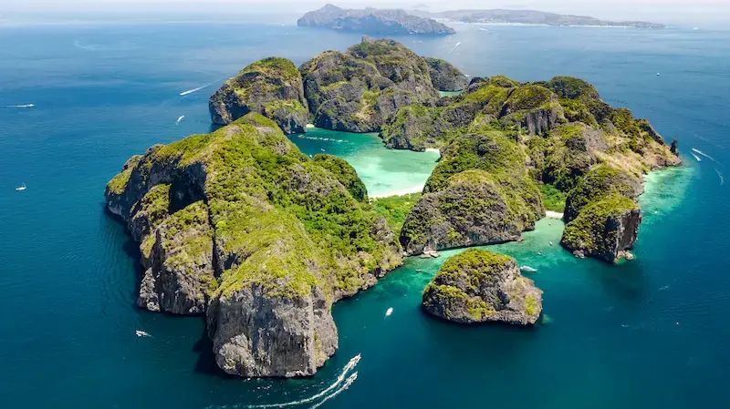 Aerial drone photo of the karst scenery and stunning blue waters of Maya Bay in the Phi Phi Islands.