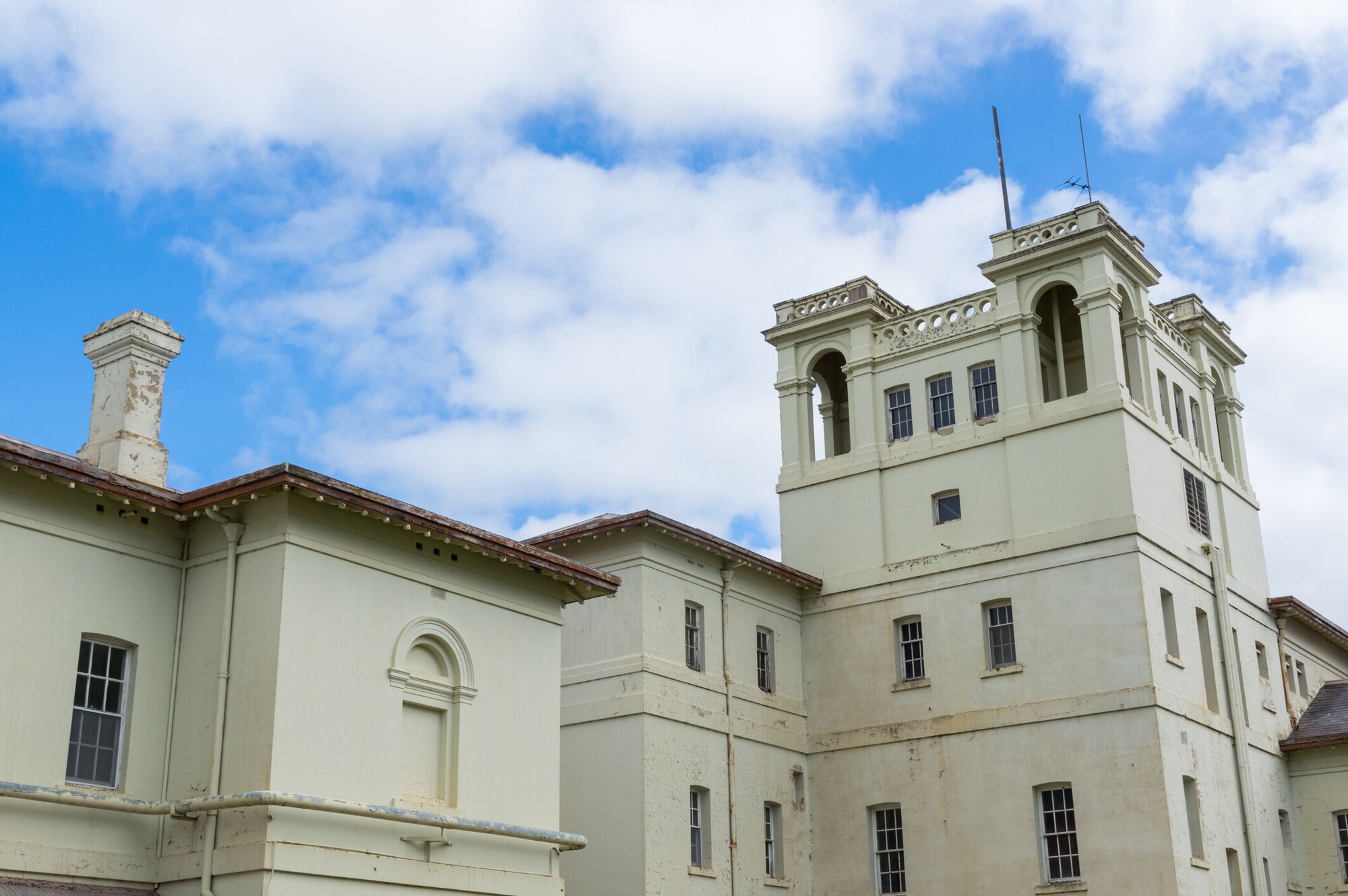Historic Aradale Lunatic Asylum in Ararat, Australia, against a blue sky backdrop