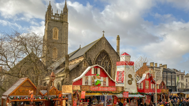 A colour image of food stalls in the Cardiff Festive Quarter in the city centre during Christmas time. To illustrate a blog post entitled 'Extreme Day Trips - UK Christmas Markets Edition'.