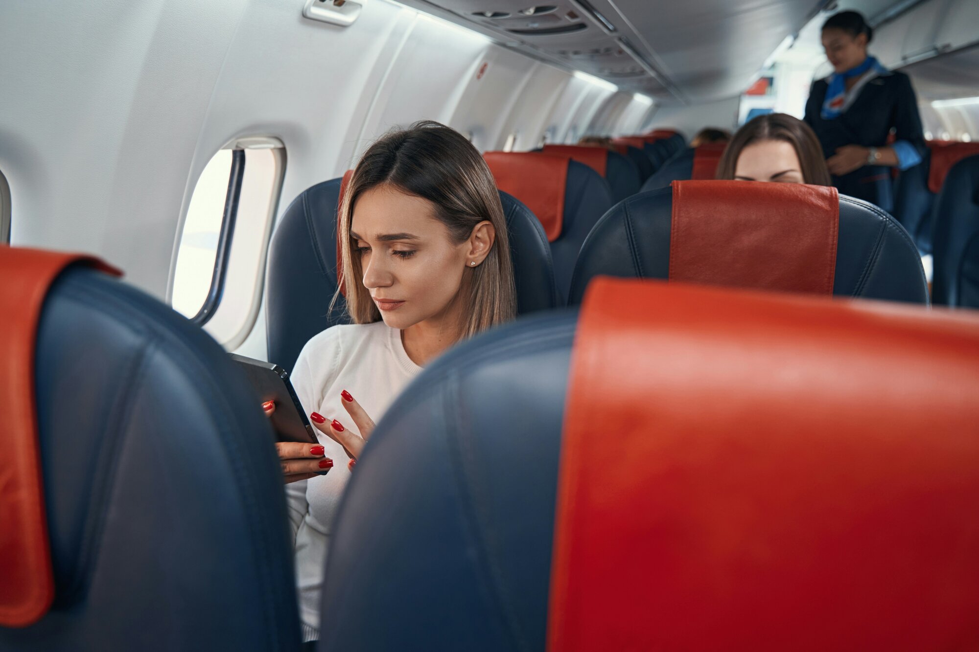 A woman on the phone on a plane