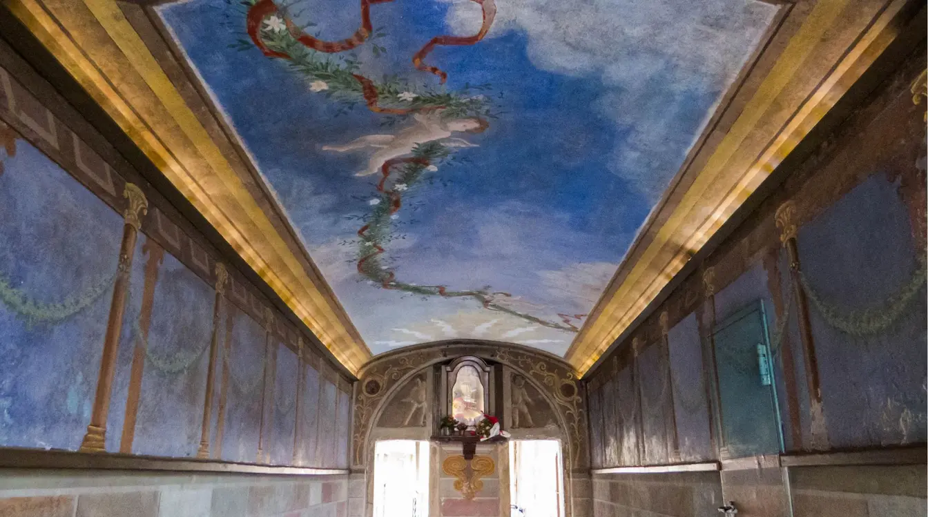 View of a sky blue fresco with a cherub in the historic Passetto del Biscione passageway in Rome.