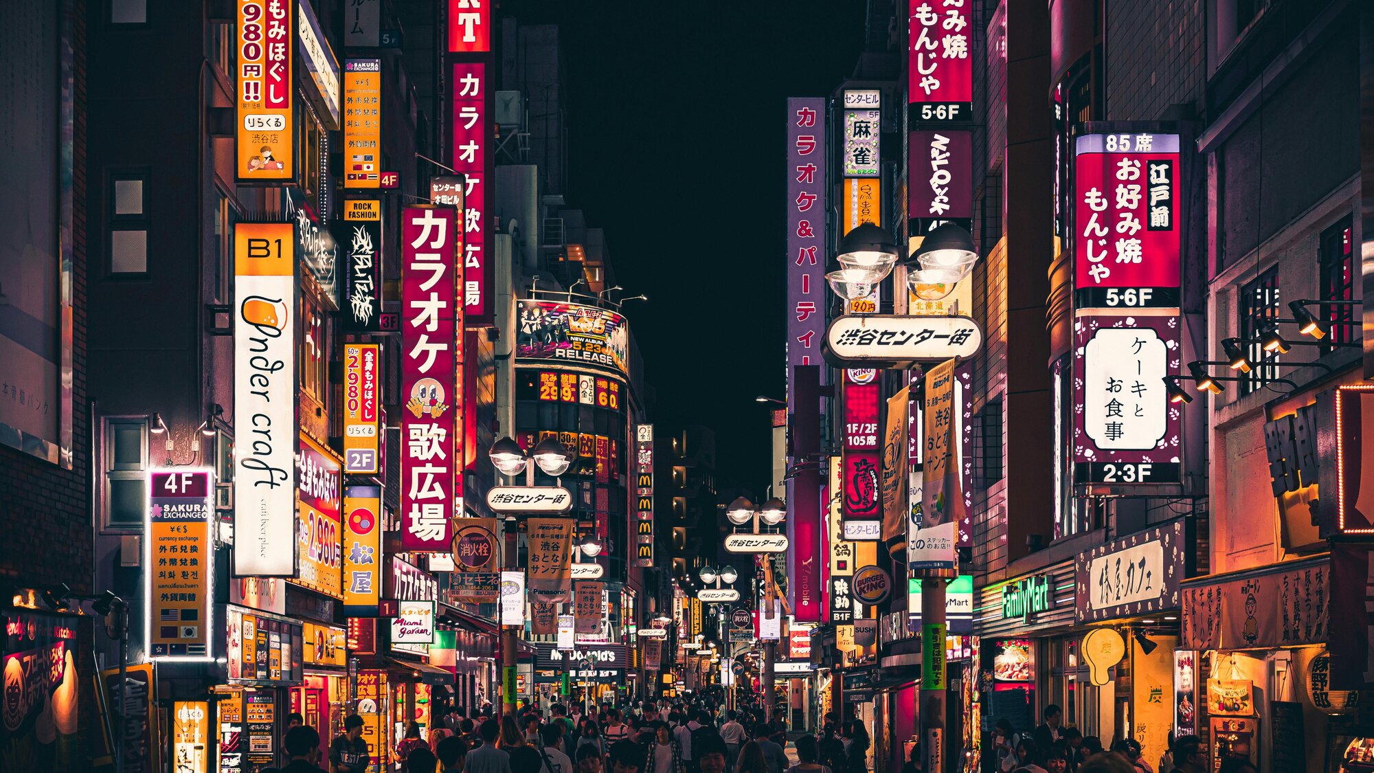 Tokyo's famous neon lights along a busy street at night