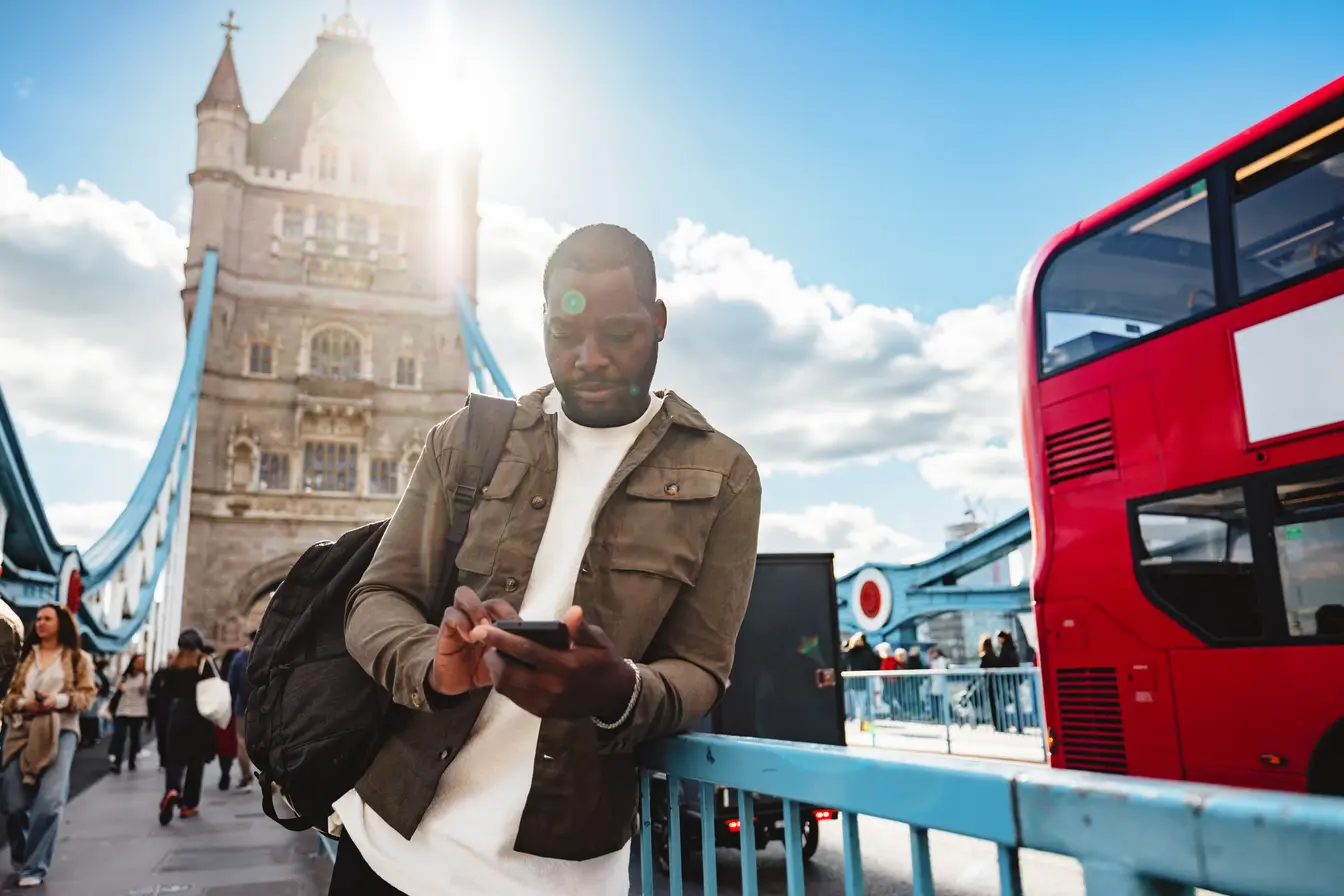 Ein Mann mit Internet in England benutzt sein Handy, um sich auf der Straße zu orientieren