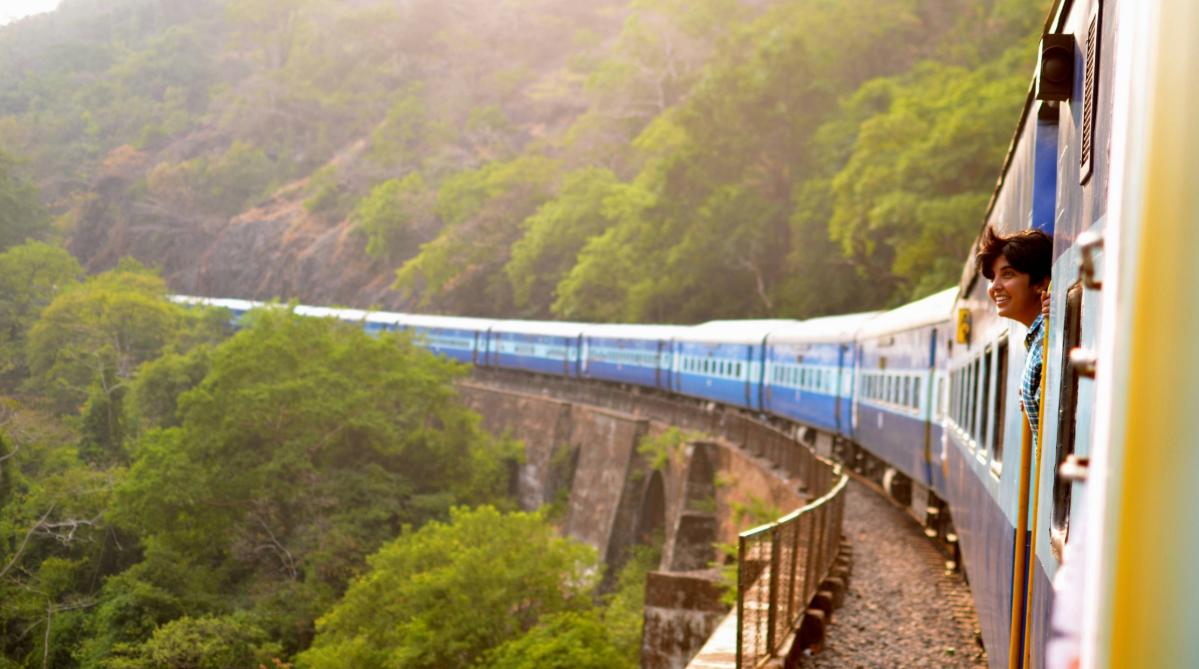 Traveler looking out a train window in India
