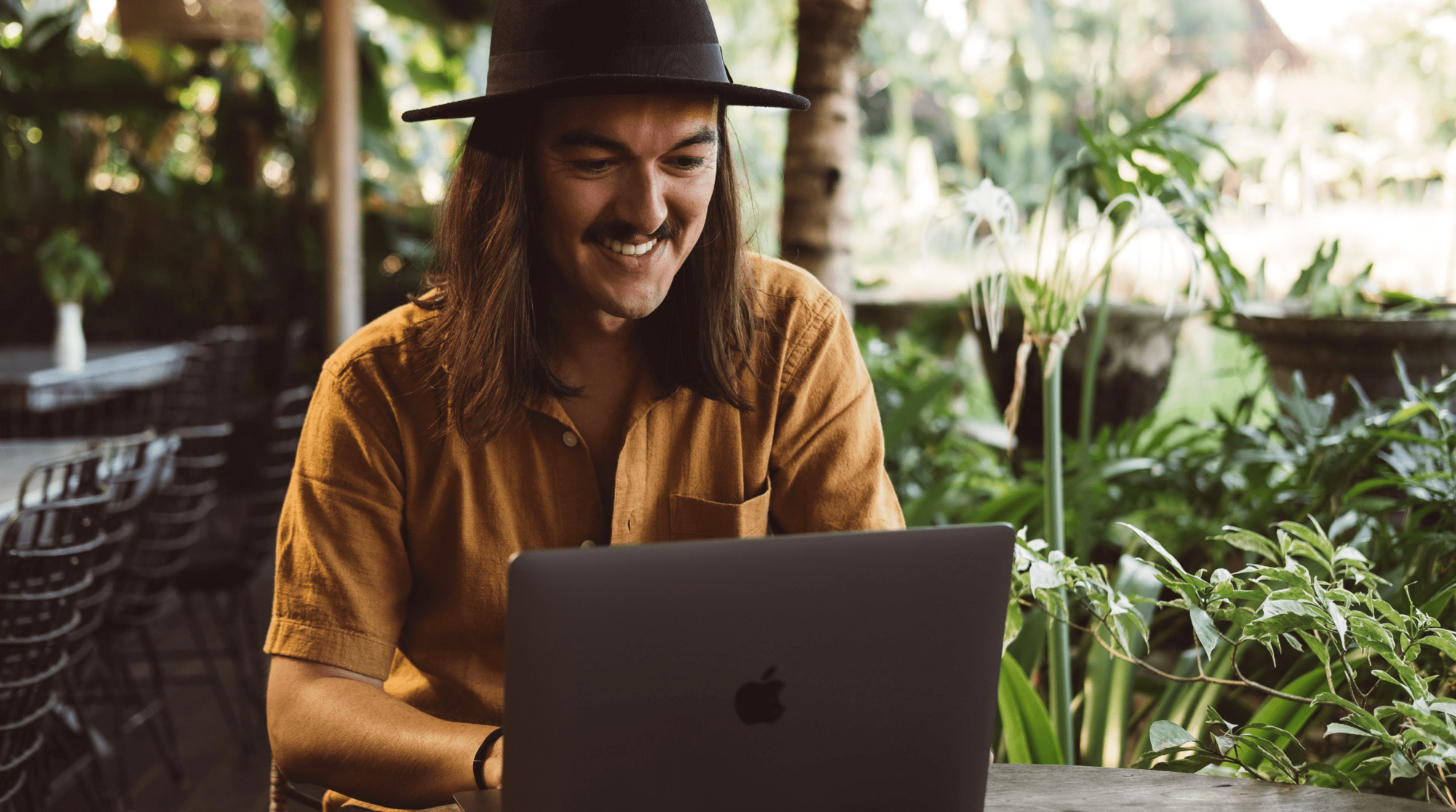 digital nomad working outside on a laptop