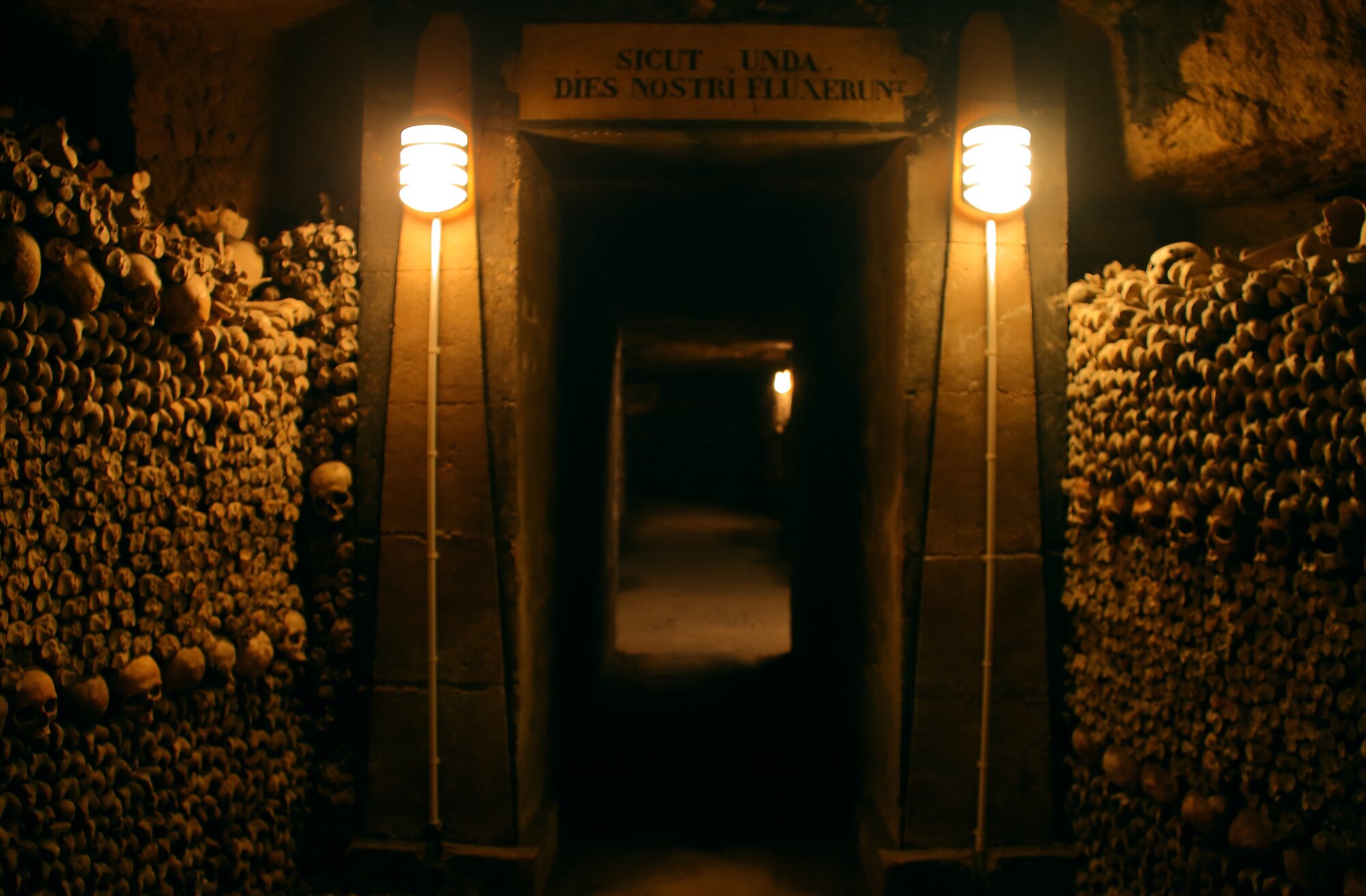 The Paris catacombs, filled with skulls and dimly lit