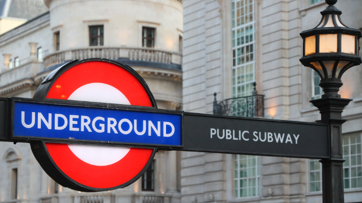 A London underground sign, with its 'bullseye' design, a red circle and a horizontal blue rectangle across the front