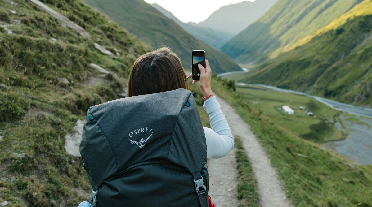 woman taking a photo on a hike