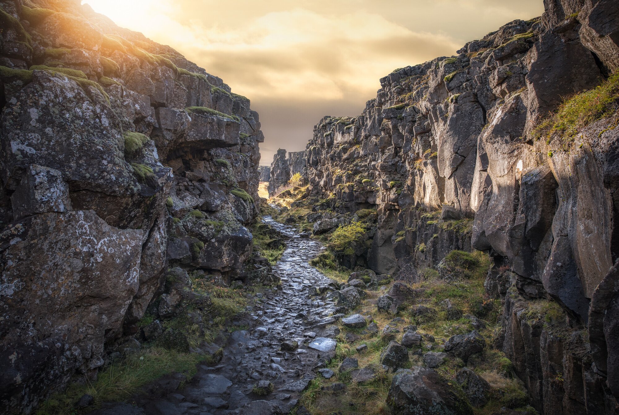 Setting sun between rock walls in the Thingvellir National Park, Iceland