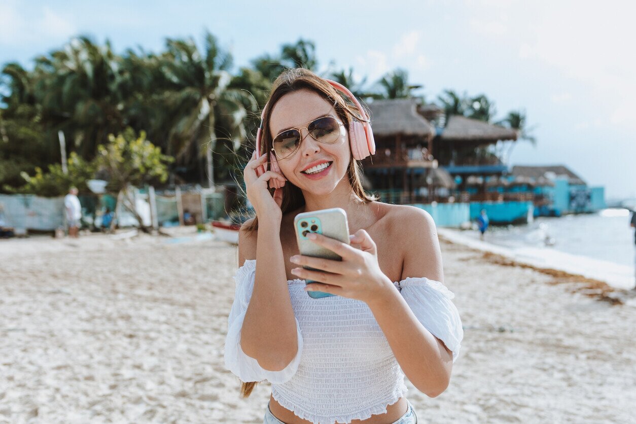 Woman with phone at the beach in Mexico