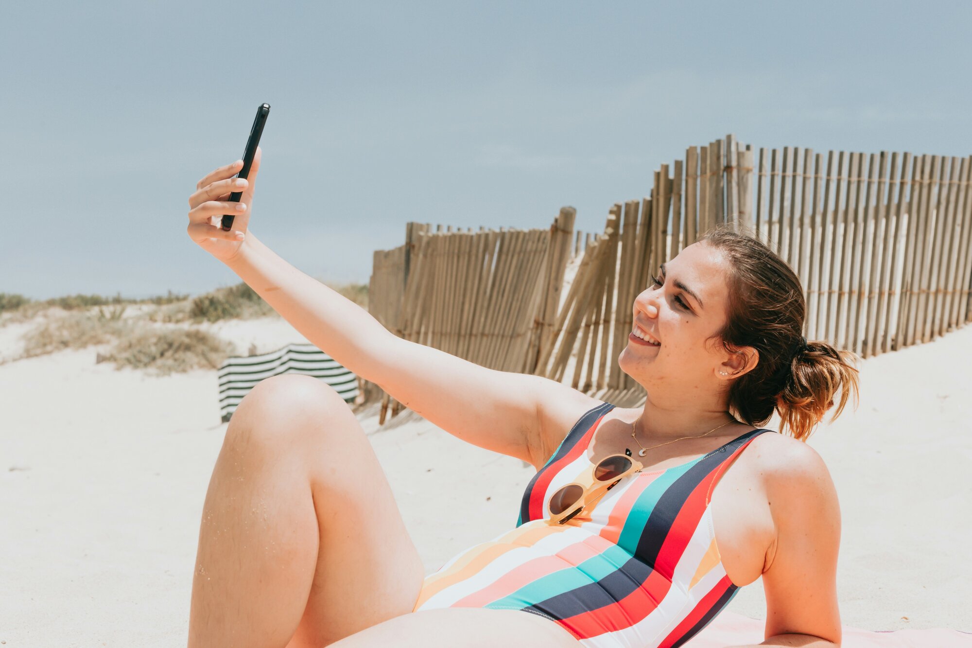 Woman at the beach using her phone