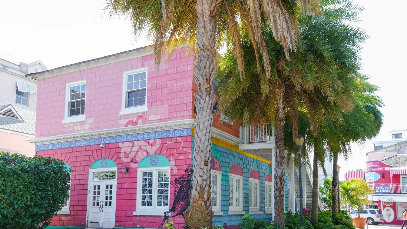 Pompey Museum, a pink and blue building in Nassau, Bahamas
