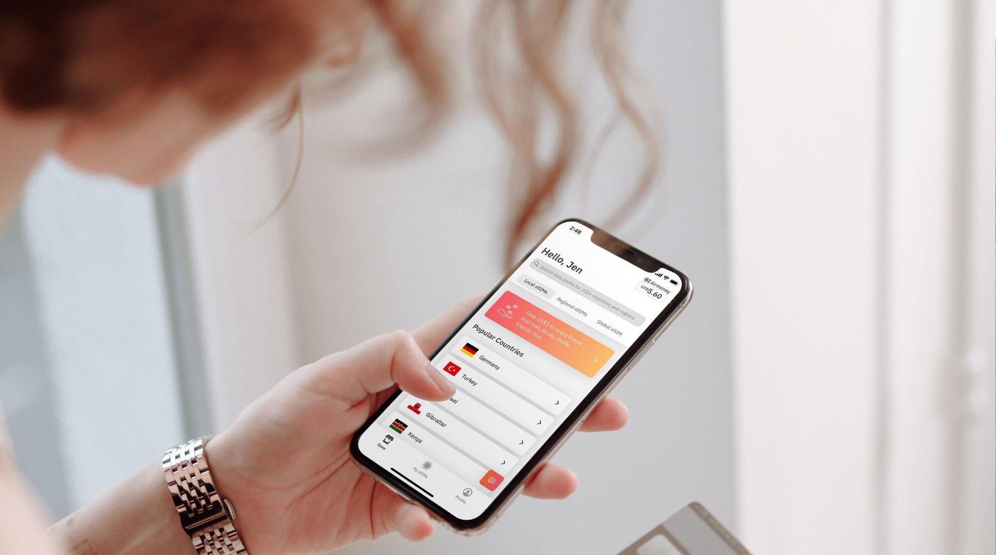 Woman using Airalo app for eSIM