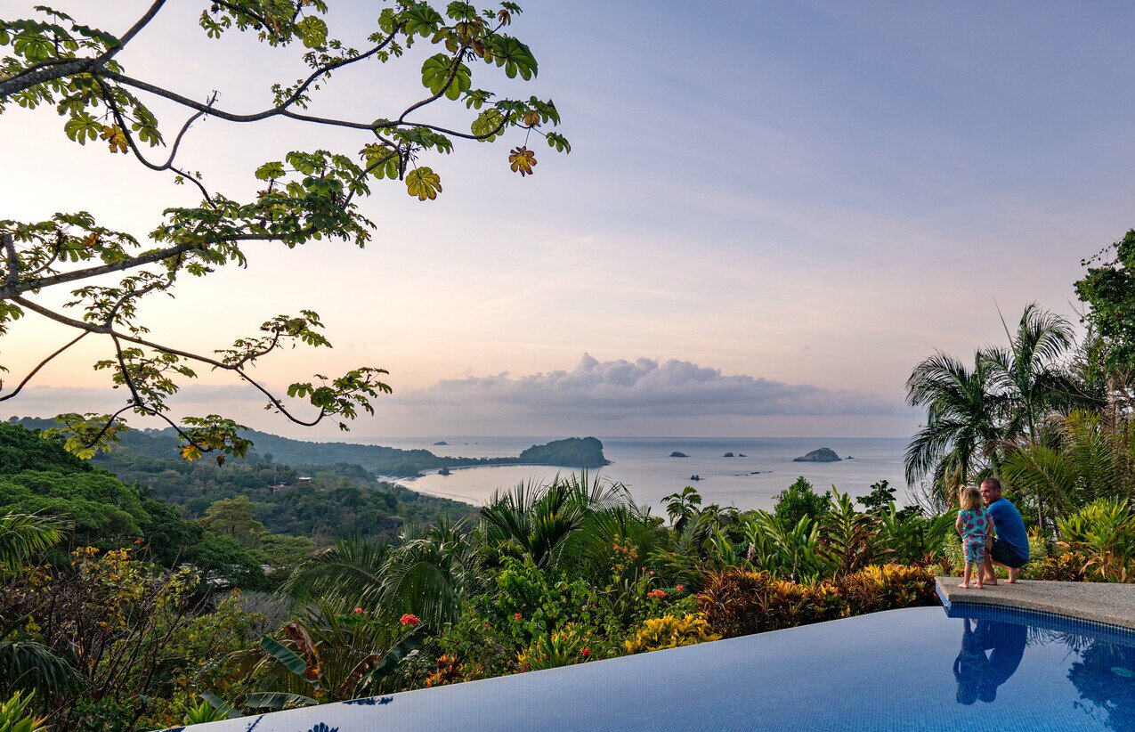 Dad and daughter watching the sunrise in Costa Rica