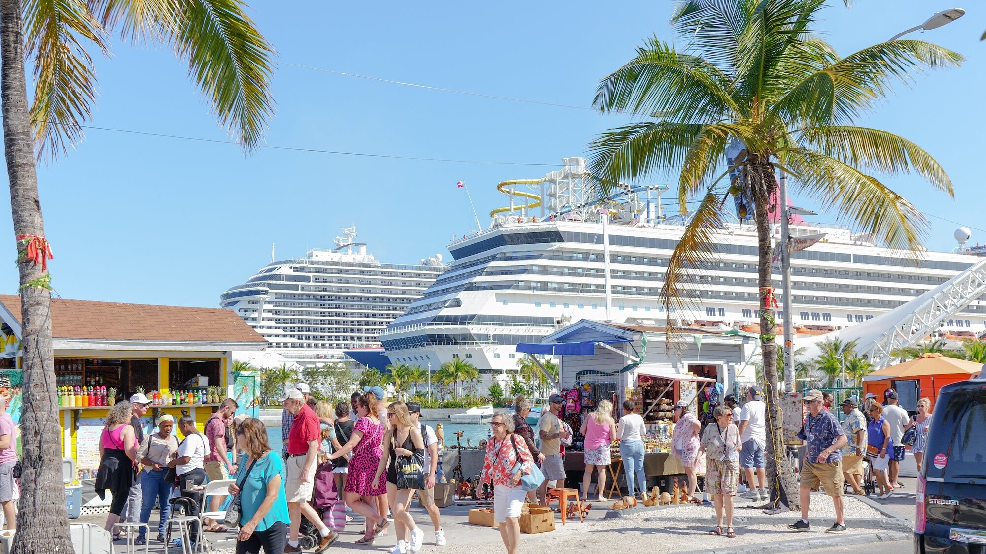 Tourist crowds next to cruise ships, in the Bahamas
