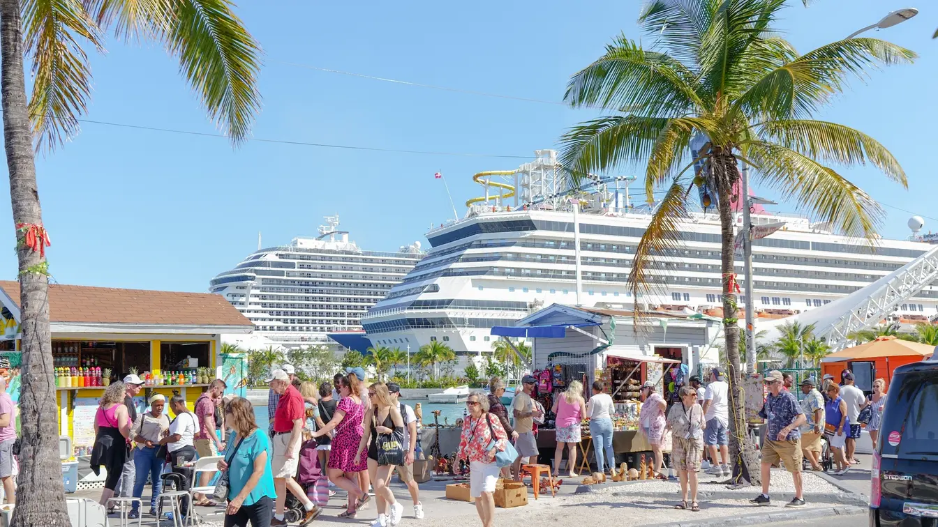 Tourist crowds next to cruise ships, in the Bahamas