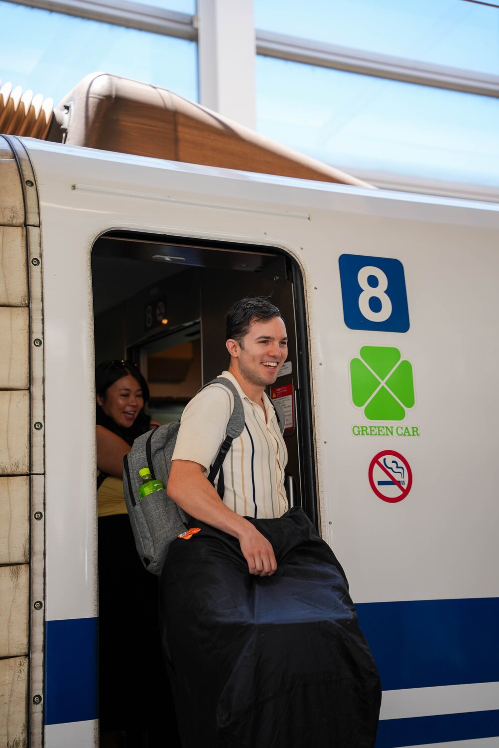 Man exiting a Shinkansen's green car