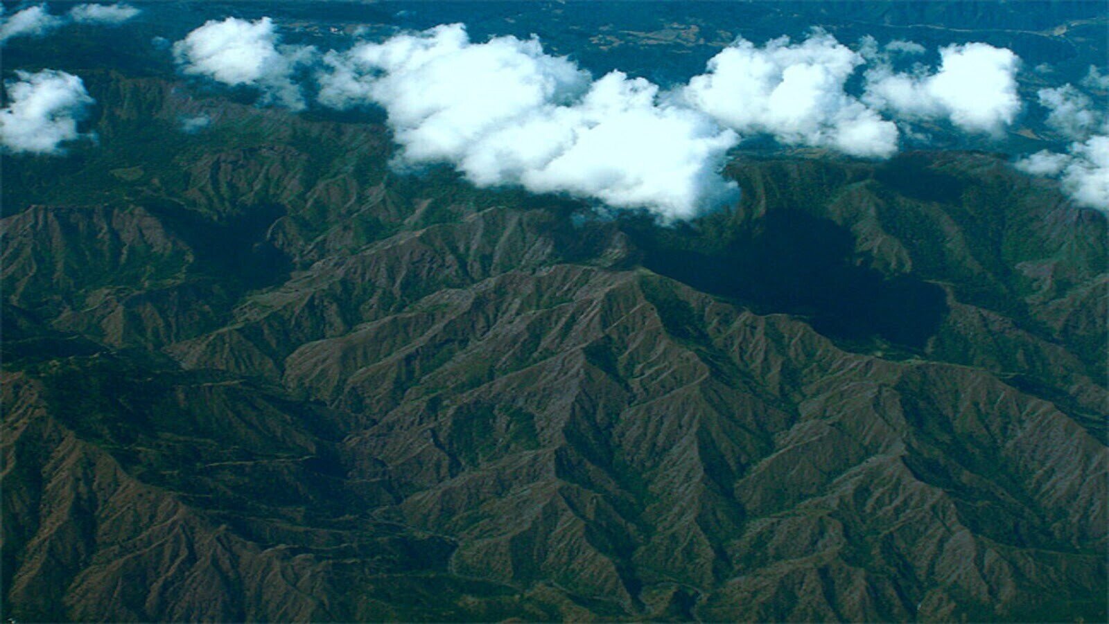  Aerial view of mountains with white clouds