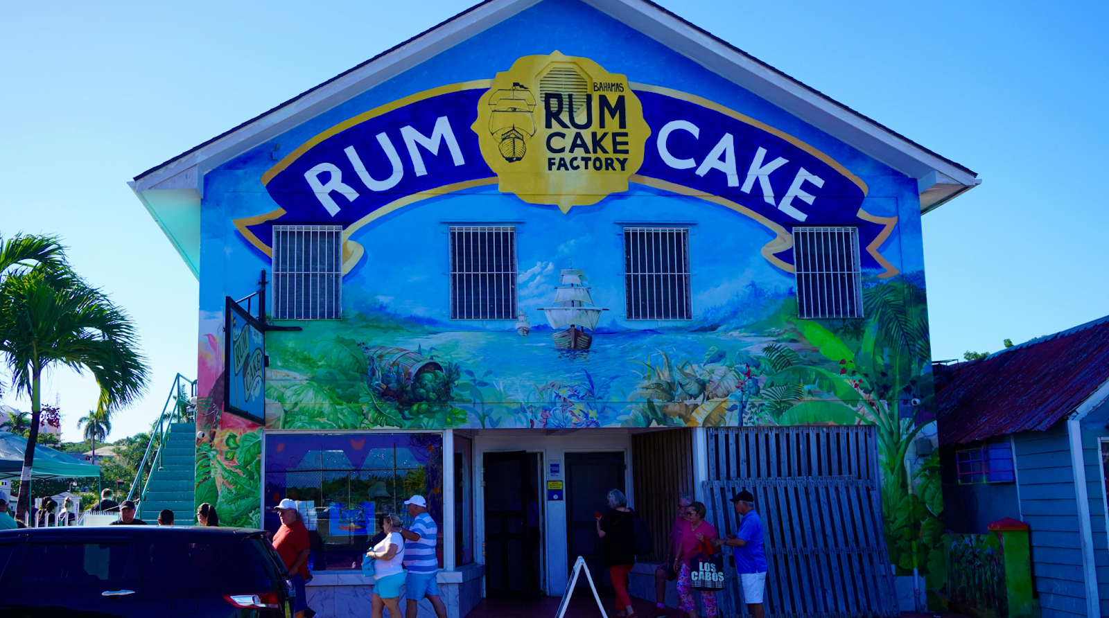 Brightly painted facade of the Rum Cake Factory in Nassau, Bahamas, a must-visit for foodies.