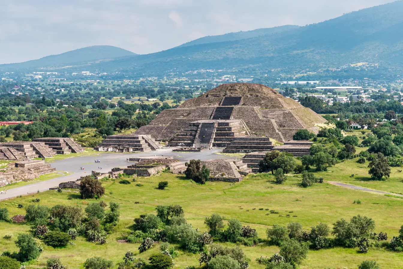 The Pyramids of the Sun and Moon at Teotihuacán, surrounded by green landscape outside Mexico City.