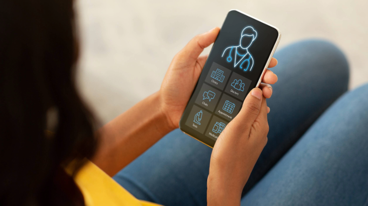 An image of the back of a woman's head, looking down on her phone screen, which displays essential medical information for her, to illustrate a blog post entitled 'Is My iPhone eSIM-Compatible?'