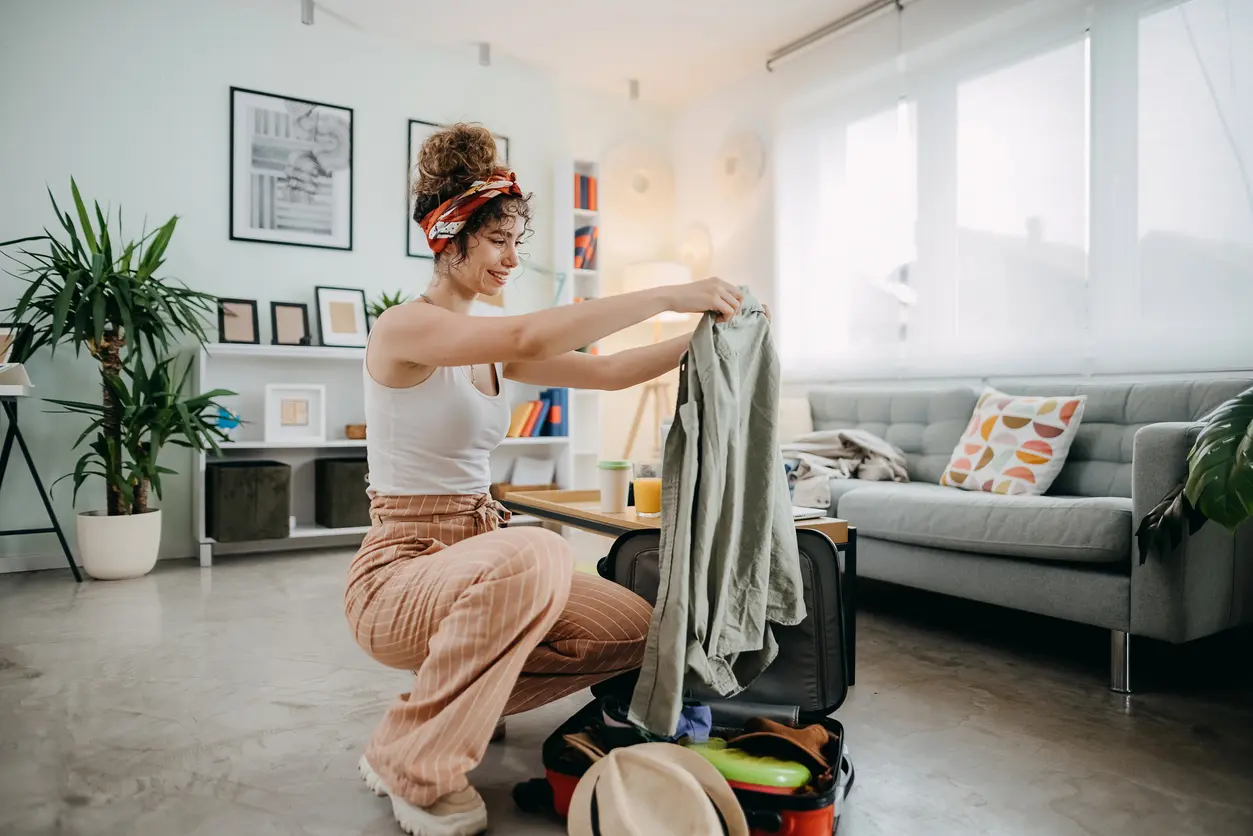 Woman packing clothes in her suitcase for the Osheaga music festival