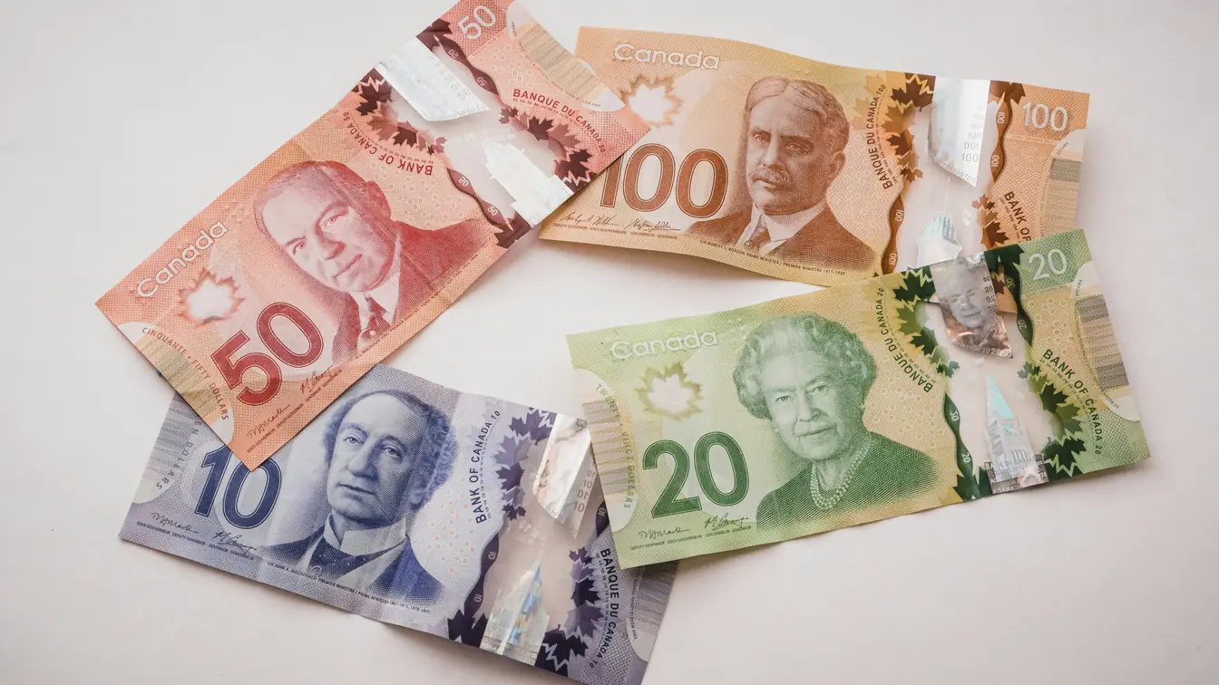 Imagen de varios billetes de dólar canadiense, con valor de 10, 20, 50 y 100 dólares para ilustrar tips para Toronto.