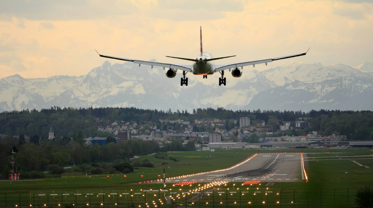 Airplane landing at an airport in the Swiss alps.