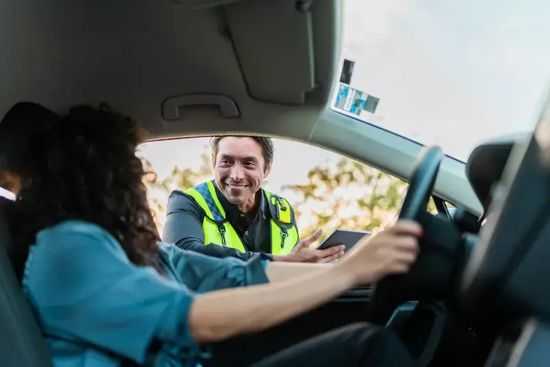 Mujer dentro del auto durante un cruce por carretera a Estados Unidos, en una situación de viaje de corta estancia.