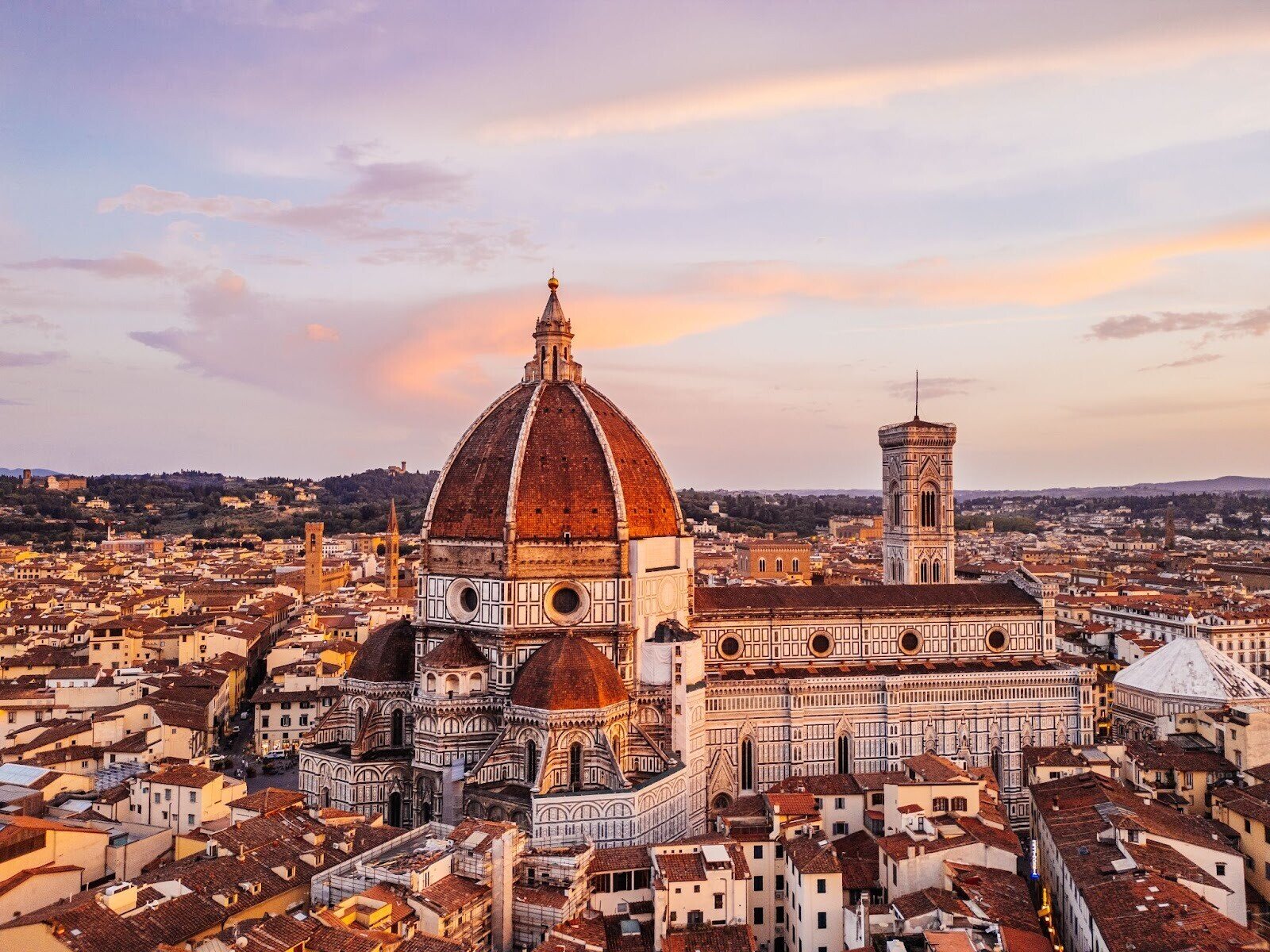 Aerial view of the Florence Cathedral with a colorful sky in the background