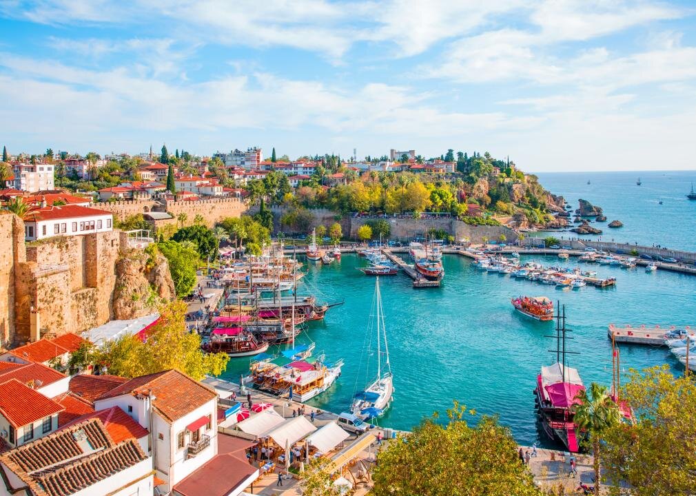 A high-up view of the old town Kaleici in Antalya, with boats docked in the harbor.