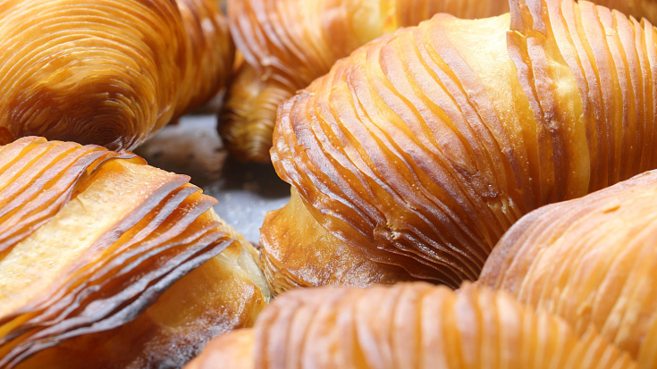 A close-up colour image of sfogliatella, a shell-shaped sweet pastry local to Salerno, made up of crisp golden layers.
