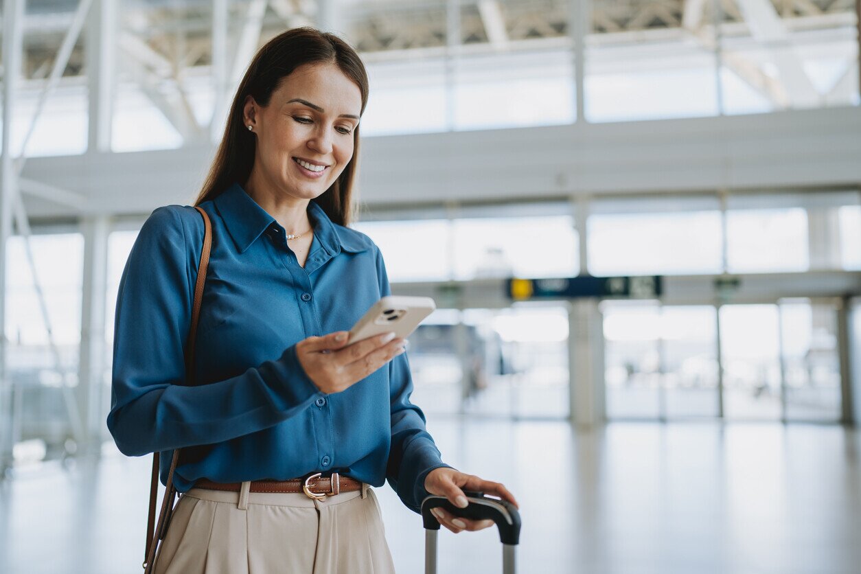 Woman with her phone at the airport