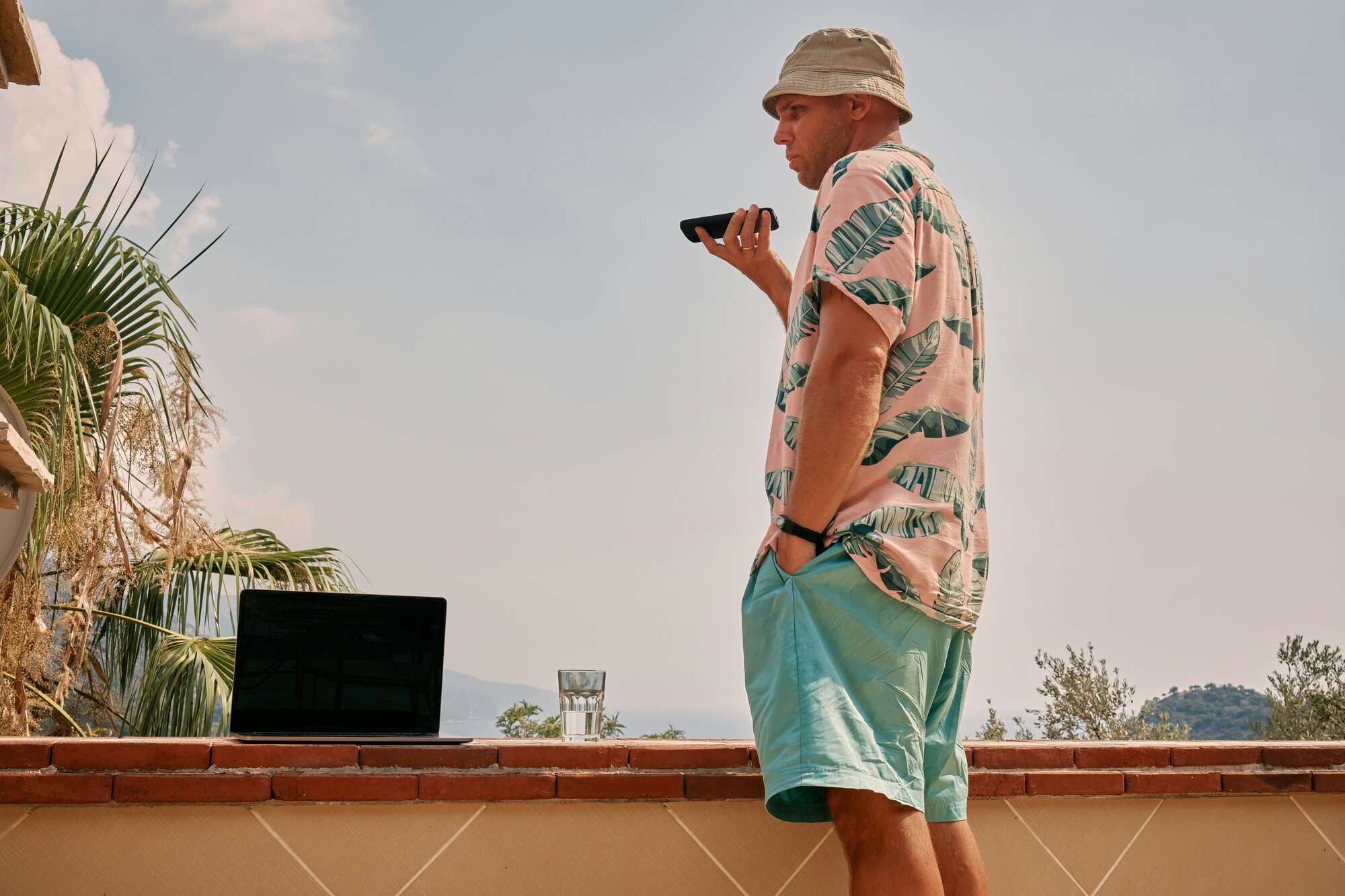 Man on the phone in a tropical location