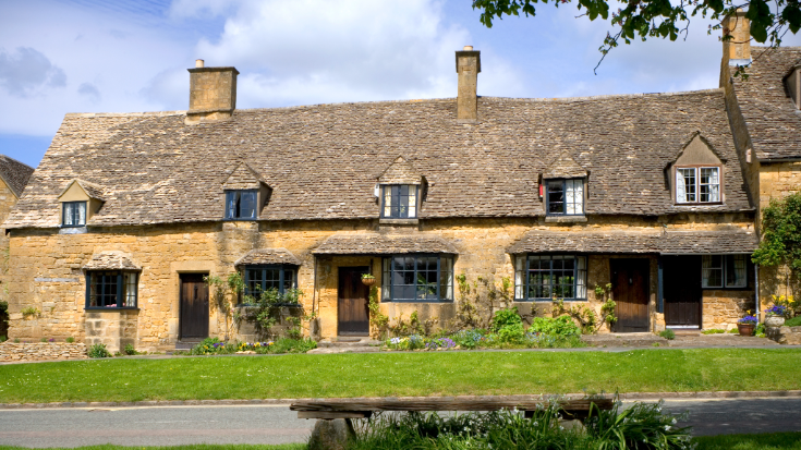 A row of honey-coloured stone cottages in Broadway in the UK's Cotswolds area.